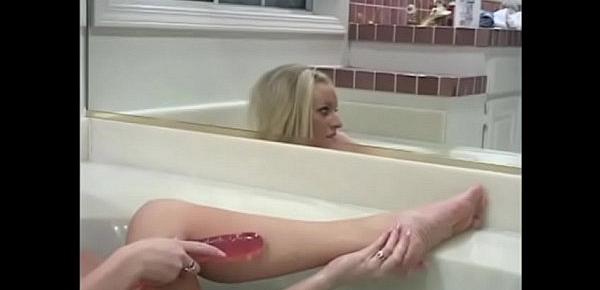  Stunning blonde Cailey Taylor with big boobs is fond of having a lark with her feet before playing with big pink dildo in hot tub